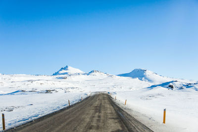 Scenic view of snowcapped mountains against clear blue sky