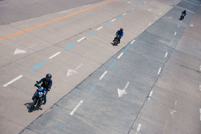 High angle view of people walking on road