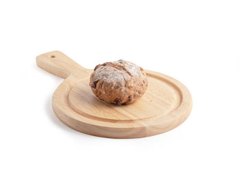 High angle view of bread on cutting board against white background