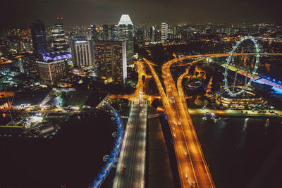 High angle view of illuminated bridges by singapore flyer at night