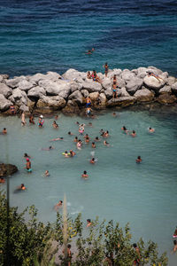 High angle view of people swimming in sea