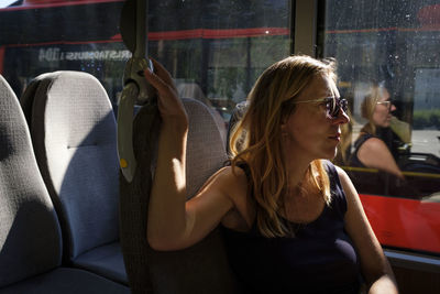 Midsection of woman sitting in bus