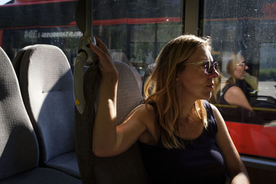 Midsection of woman sitting in car