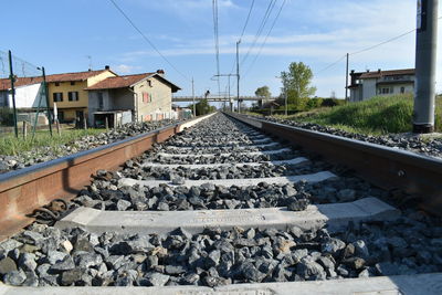 Railroad track amidst rocks against sky