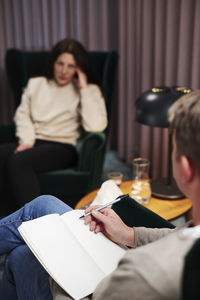 Male doctor taking notes at therapy session