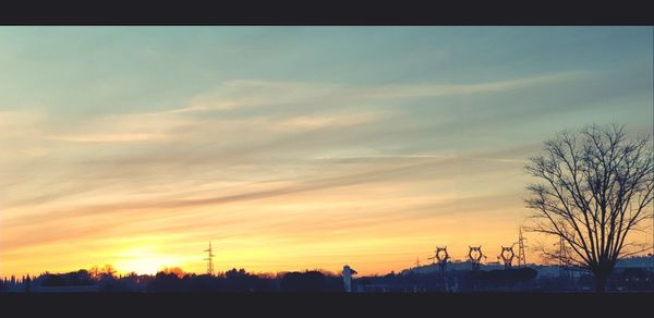 Silhouette of buildings against sky during sunset