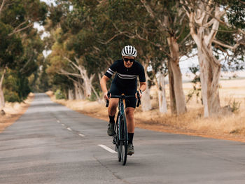 Man riding bicycle on road