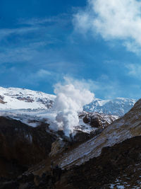 Aerial view of snowcapped mountains against sky