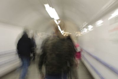 Rear view of people walking on staircase