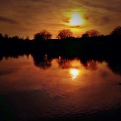 Scenic view of lake at sunset