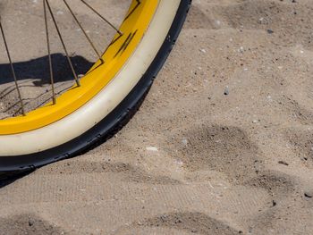 Close-up of bike wheel in the sand