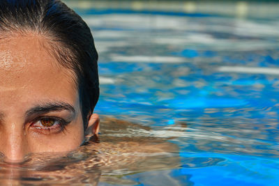 Close-up portrait of young woman in swimming pool