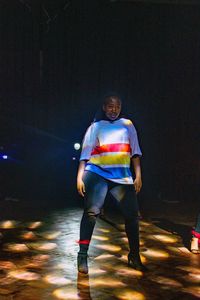 Portrait of senior man on illuminated stage at night