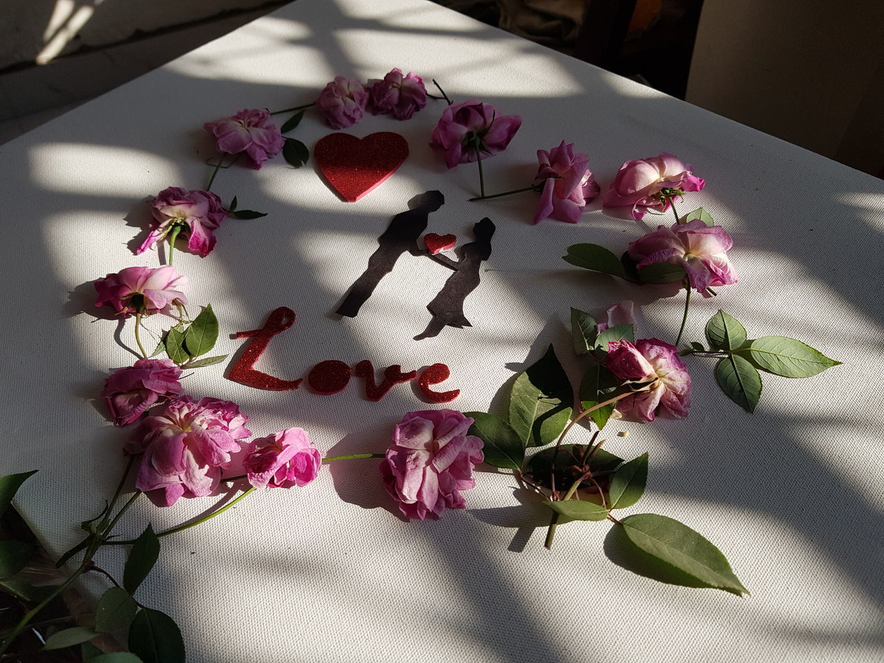 CLOSE-UP OF PINK FLOWERS ON TABLE