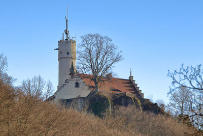 Medieval castle in the woodlands on the top of the mountains