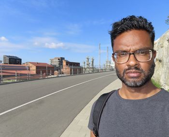 Portrait of man on road against sky