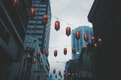 Low angle view of illuminated lanterns hanging on street in city