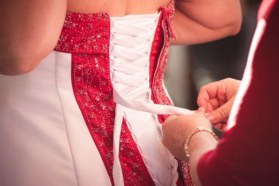 Close-up of hands holding red roses