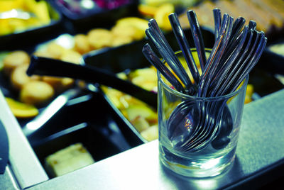 Close-up of spoons in glass