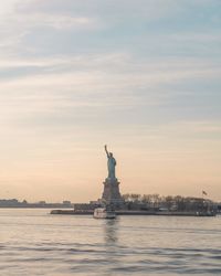 Statue of liberty against sky during sunset