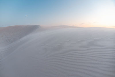 Scenic view of desert against sky during sunset