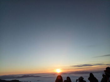 Silhouette of people at sunset