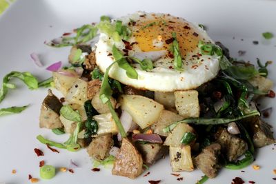 Close-up of potato with poached egg served in plate