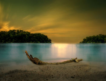 Scenic view of lake against sky during sunset