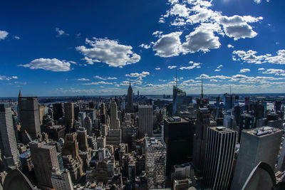 Aerial view of modern buildings in city against sky