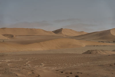 Scenic view of desert against sky during sunset