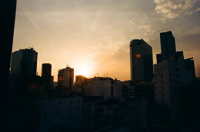 View of cityscape against dramatic sky