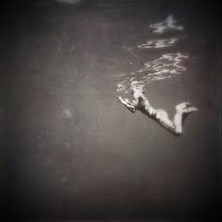 Woman with arms raised in background