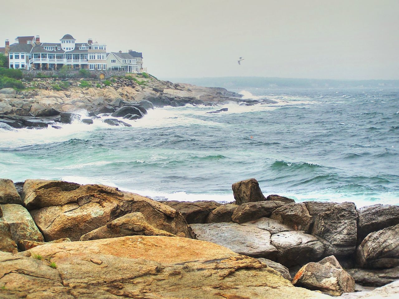 sea, water, horizon over water, rock - object, beach, shore, rock formation, rock, scenics, built structure, building exterior, sky, beauty in nature, architecture, nature, tranquility, tranquil scene, wave, clear sky, coastline