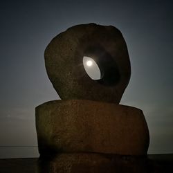 Close-up of illuminated rock against sky at dusk