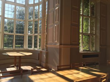 Empty chairs and table by window at home