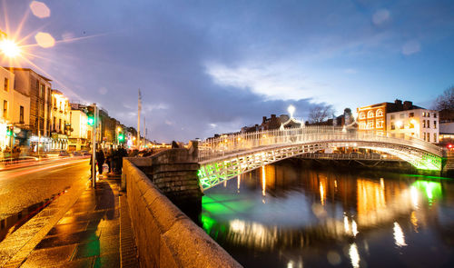 View of bridge over river at night