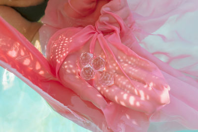 High angle view of woman holding crystal in swimming pool