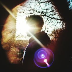 Portrait of man playing against trees