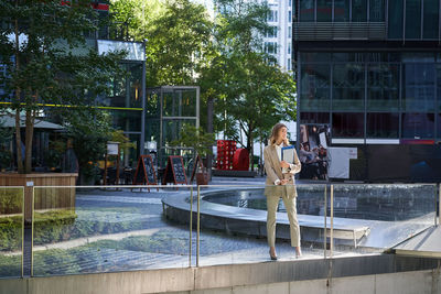 Rear view of woman standing in park