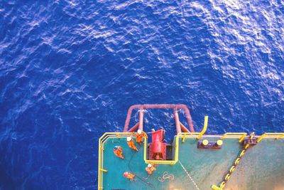 Directly above shot of workers on barge in sea