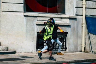 Rear view of man and woman walking in building