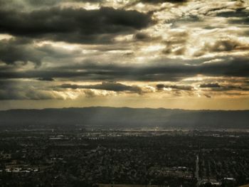 High angle view of cityscape against cloudy sky