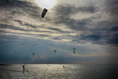 Low angle view of people enjoying at beach