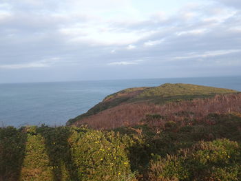 Scenic view of sea against cloudy sky