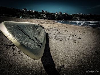 Water in sand at beach against sky