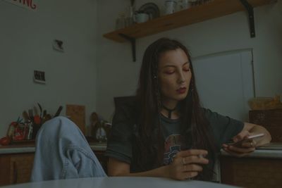 Young beautiful woman with the smartphone at home