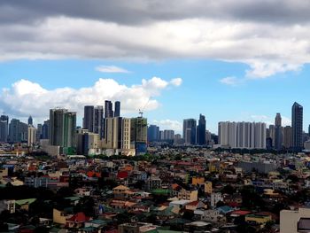 Aerial view of modern buildings in city against sky