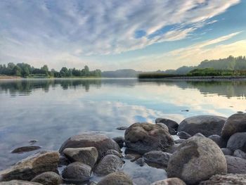 Scenic view of rocks in lake against sky