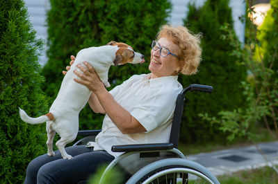 Side view of young man with dog in park