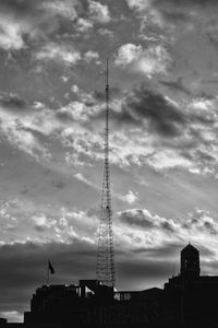 Low angle view of silhouette building against cloudy sky